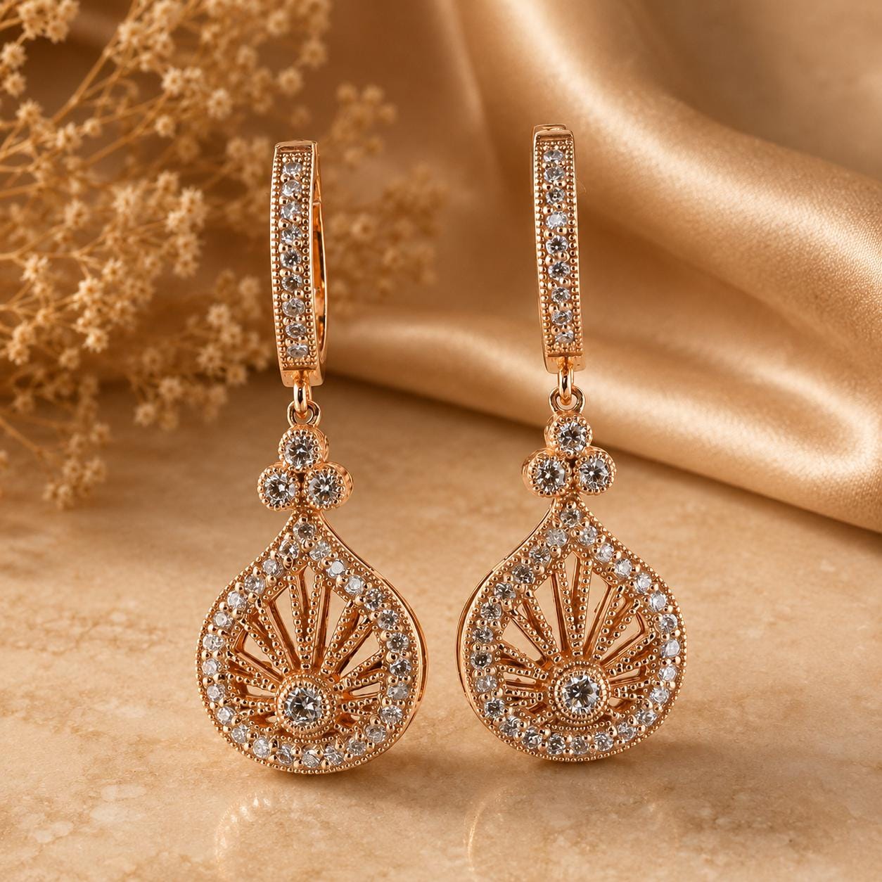 A pair of elegant gold earrings with intricate designs and sparkling gemstones, displayed on a beige fabric background.