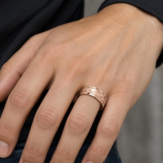 A close-up of a person's hand wearing a gold ring on the ring finger.