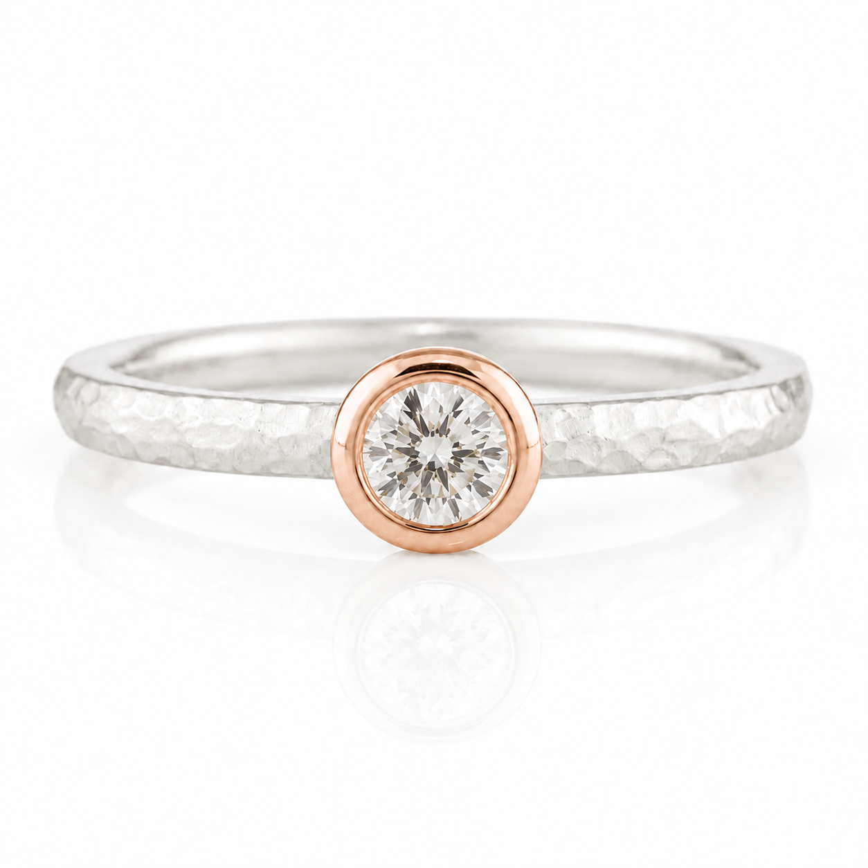 A simple yet elegant ring with a large diamond set in the center, surrounded by a thin band.