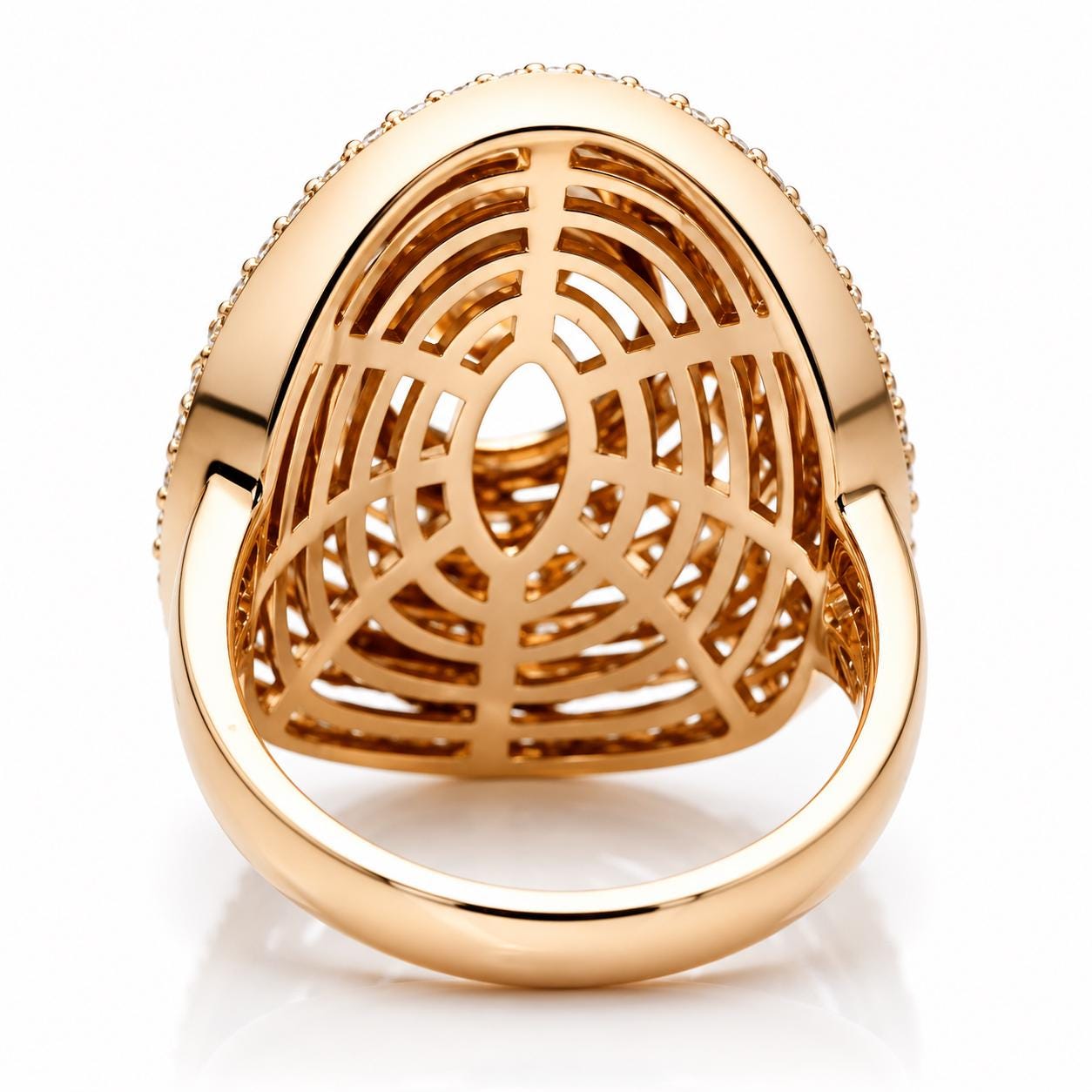 A gold ring with a large, intricate design and small diamonds set in the center.