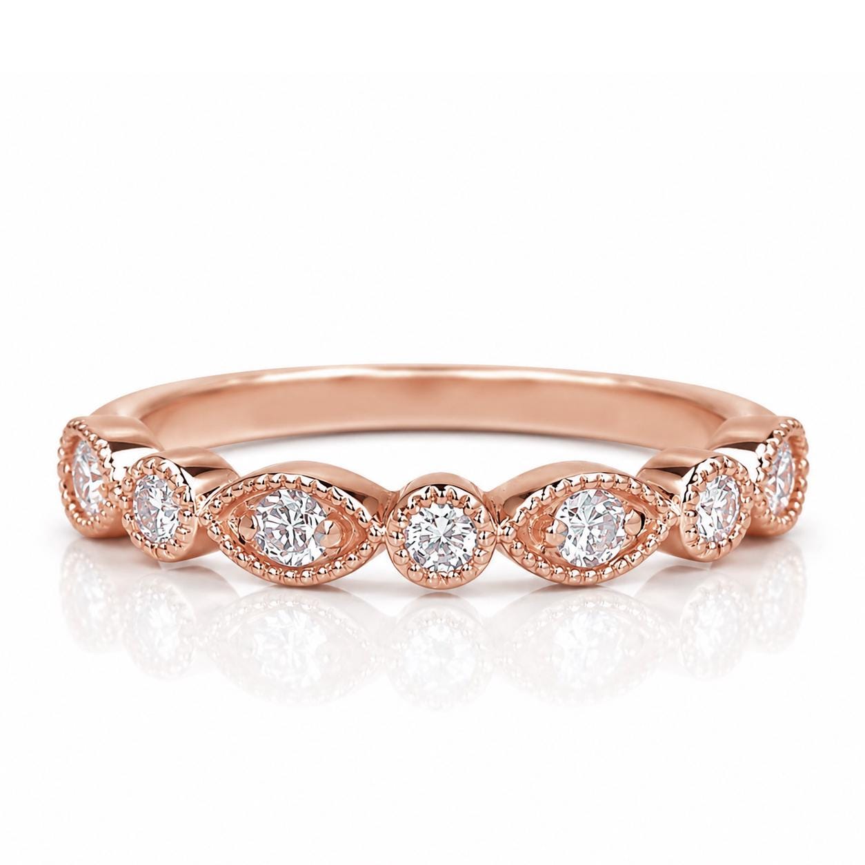 A rose gold ring with a row of small diamonds set in the center.