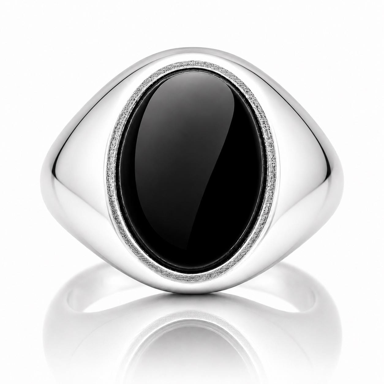 A silver ring with a large oval-shaped black gemstone in the center.