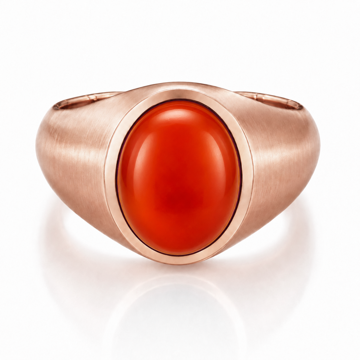 A gold ring with a large, bright red gemstone in the center.