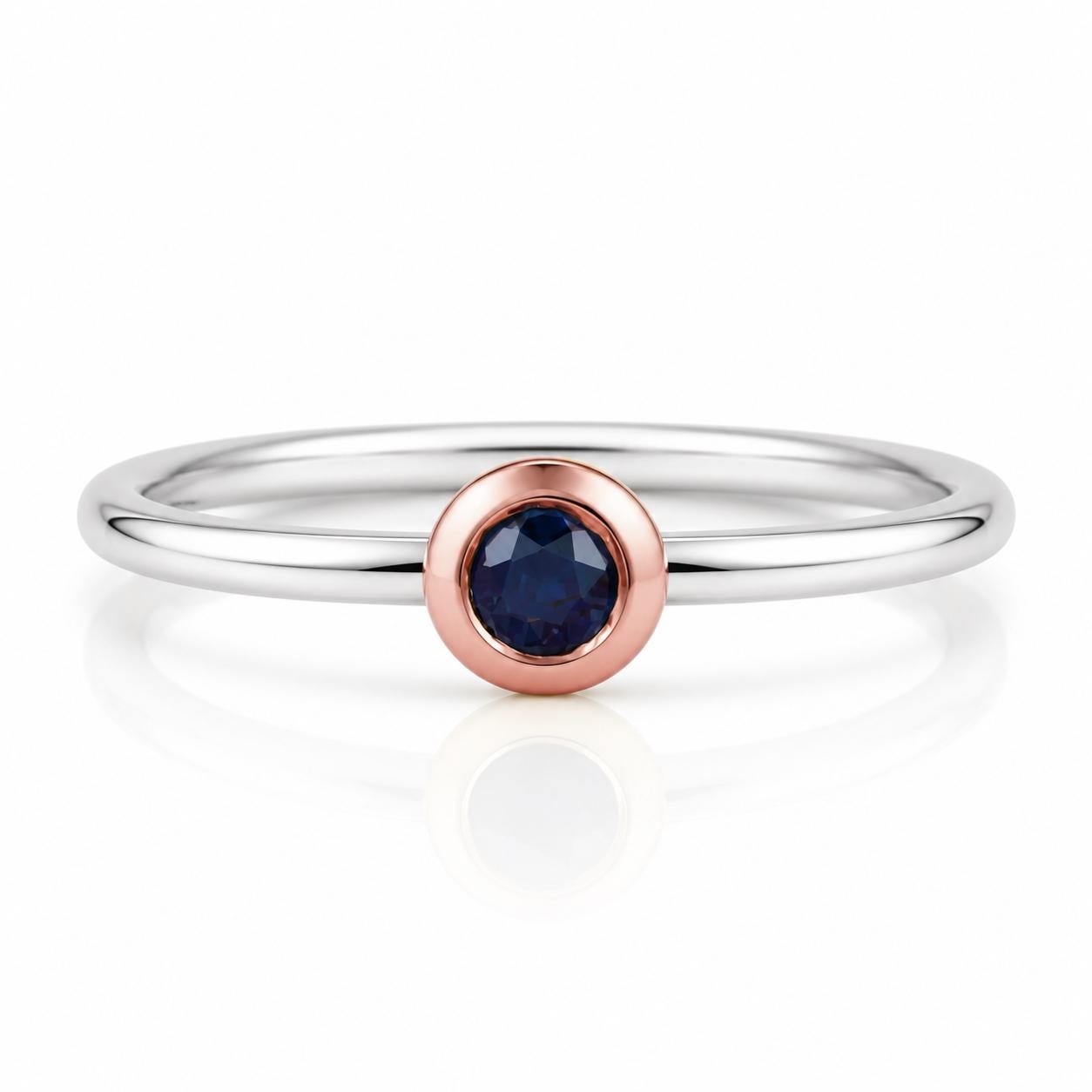 A silver ring with a blue gemstone in the center.