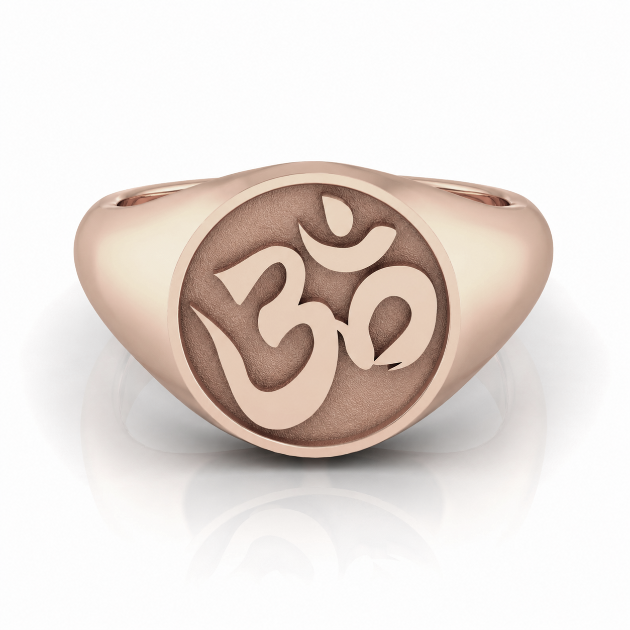 A gold-colored ring with a circular design featuring the Om symbol, which is a significant symbol in Hinduism and yoga.
