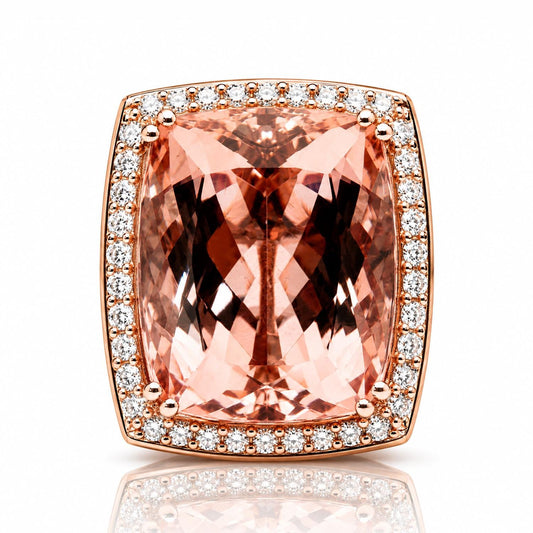 A large, pink gemstone ring with a halo of smaller diamonds around the edges.