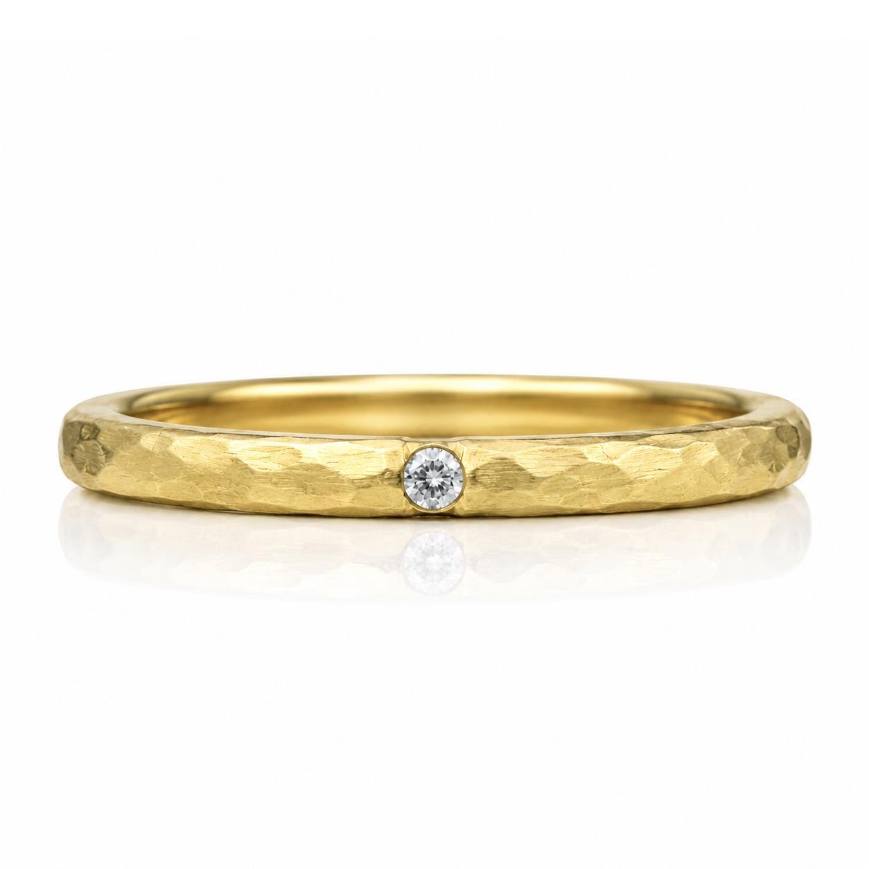 A gold ring with a diamond set in the center.
