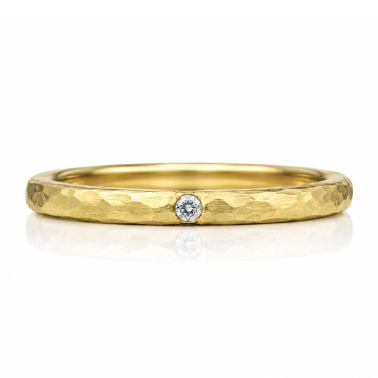 A gold ring with a diamond set in the center.