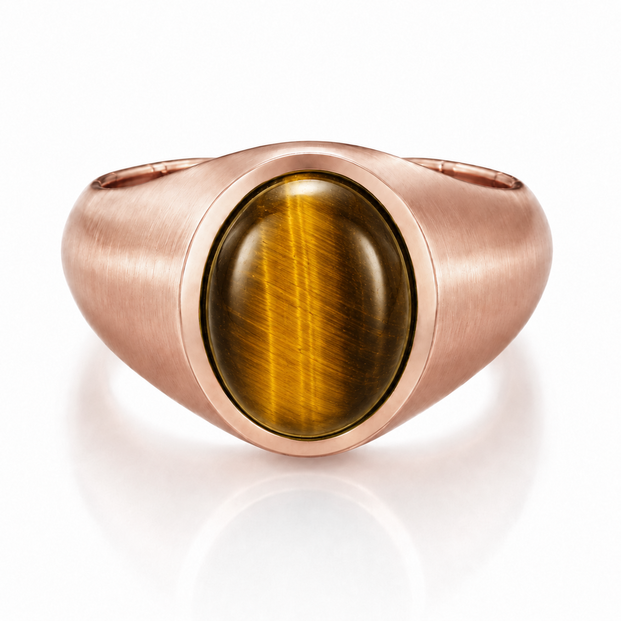 A copper-colored ring with a large oval-shaped gemstone, possibly a tiger eye, set in the center.