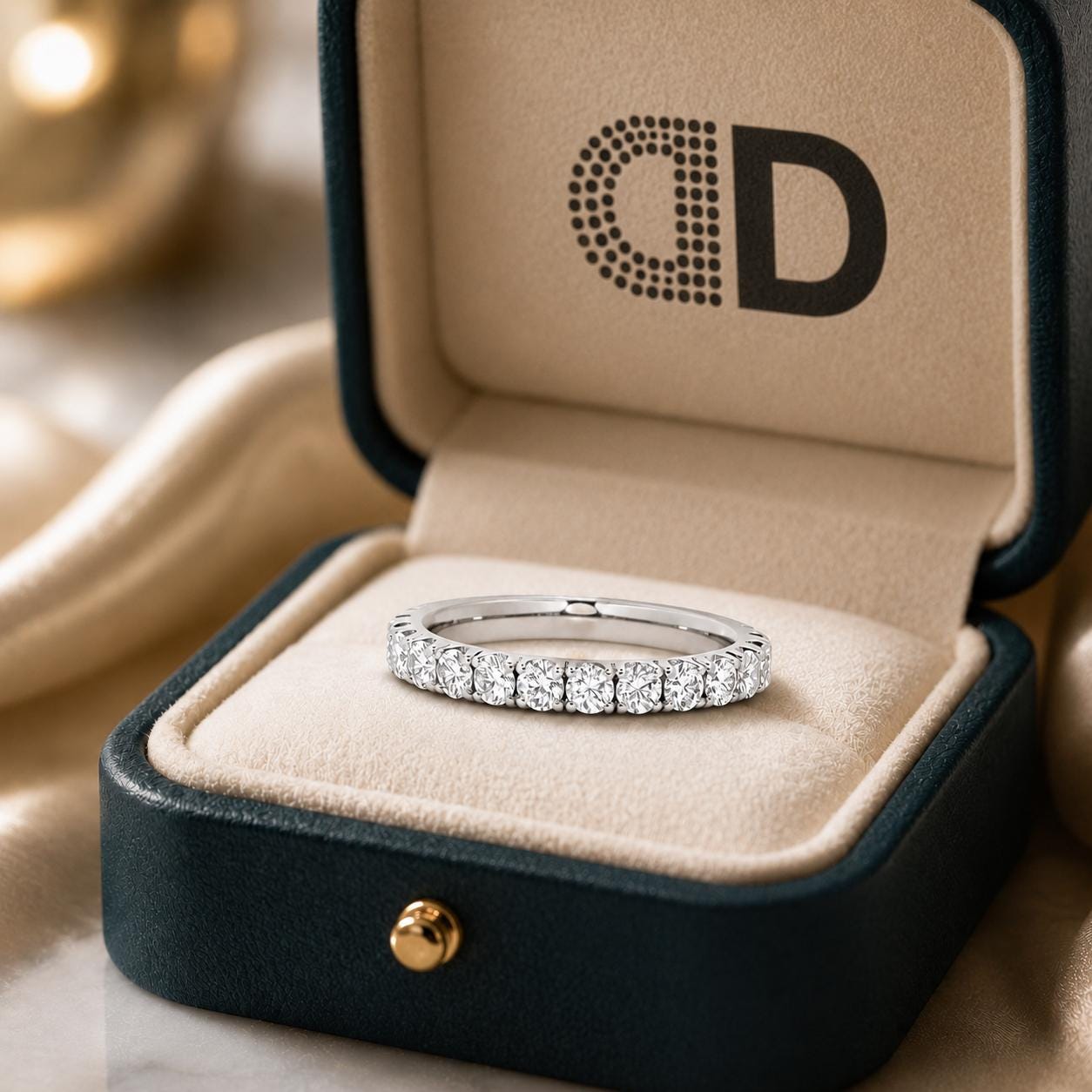 A diamond ring is displayed in a black jewelry box with a gold-colored interior, placed on a beige cloth.