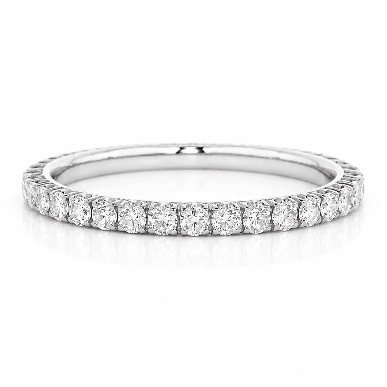 A diamond band with a row of round diamonds set in a silver-colored metal.