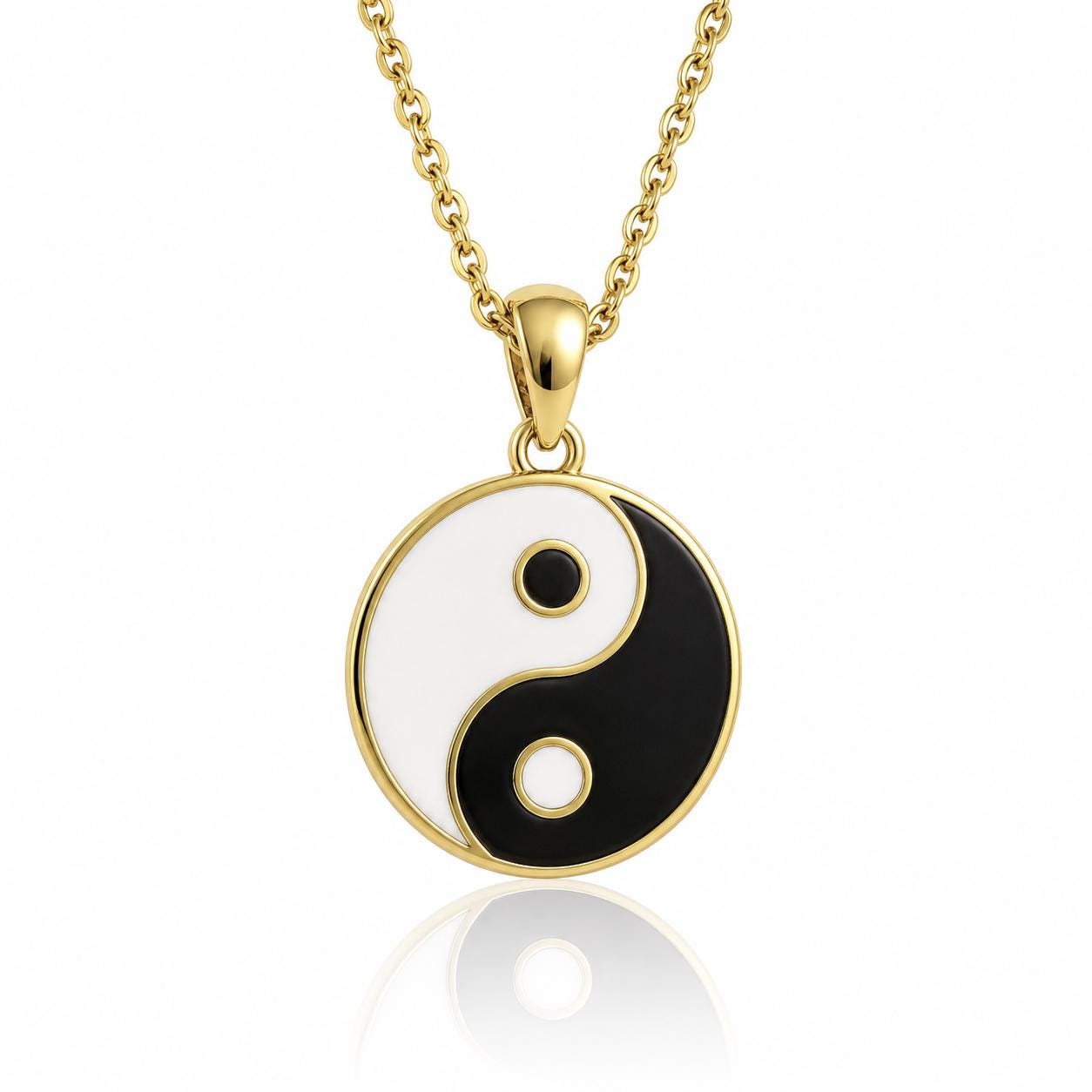 A gold-colored pendant necklace with a circular pendant featuring a black and white yin and yang symbol.