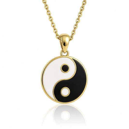 A gold-colored pendant necklace with a circular pendant featuring a black and white yin and yang symbol.