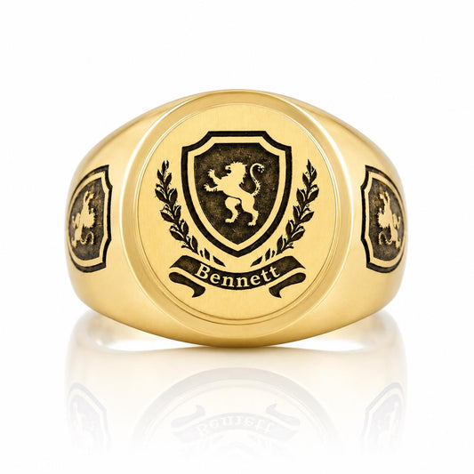 A gold ring with a shield-shaped emblem featuring a lion and laurel wreath, with the name "Bennett" written below the emblem.