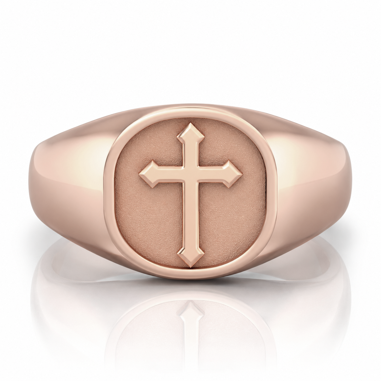 A gold-colored signet ring with a cross symbol on the front.