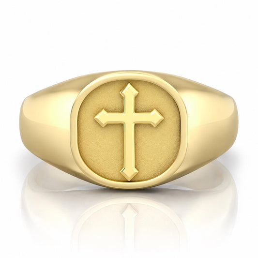 A gold ring with a large cross symbol on the front.
