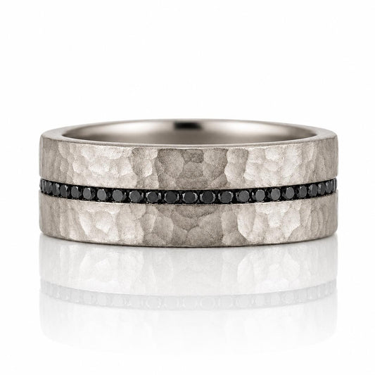 A silver-toned ring with a horizontal band of black diamonds set in the center.