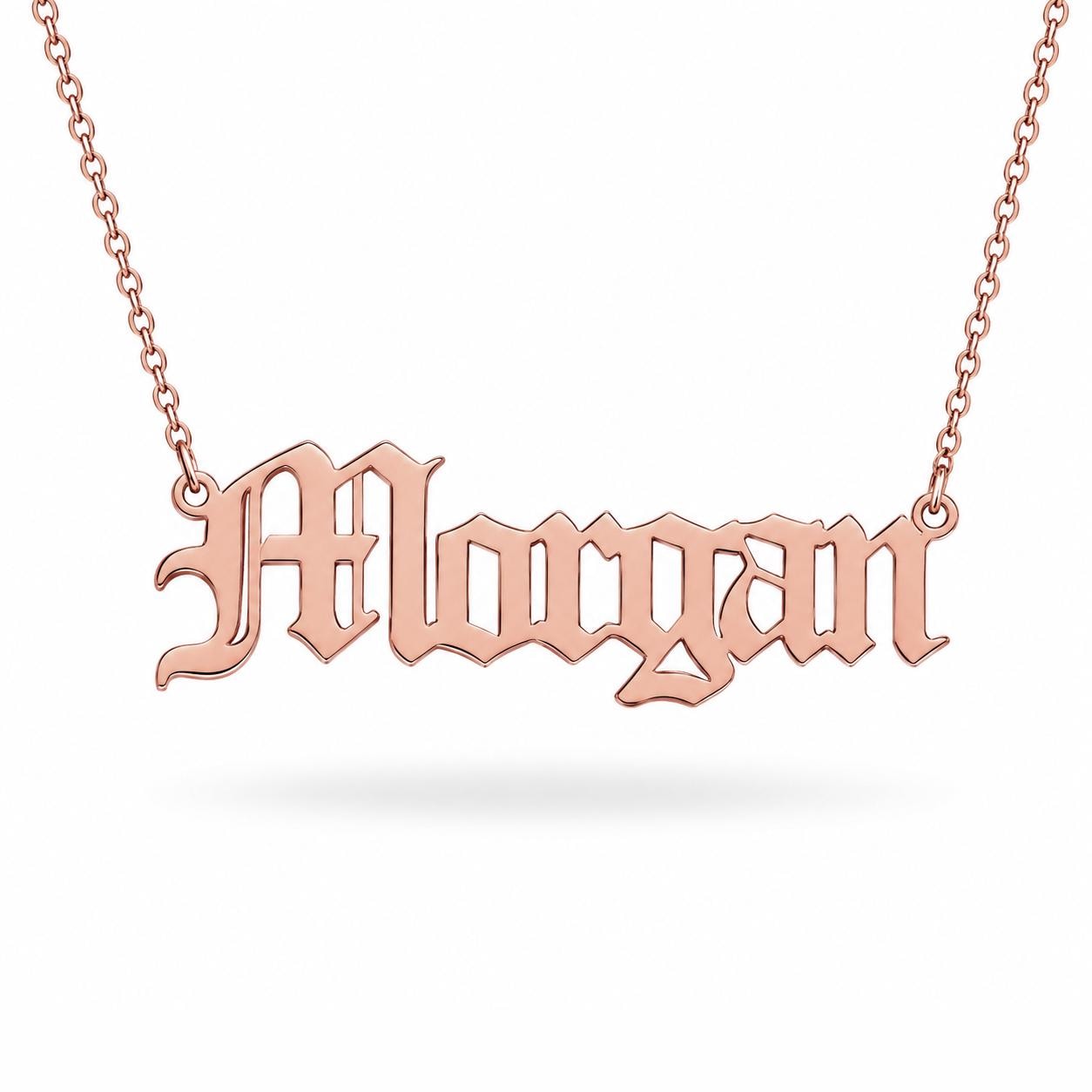A necklace with the name "Moriahgan" engraved on it in an old-fashioned style.