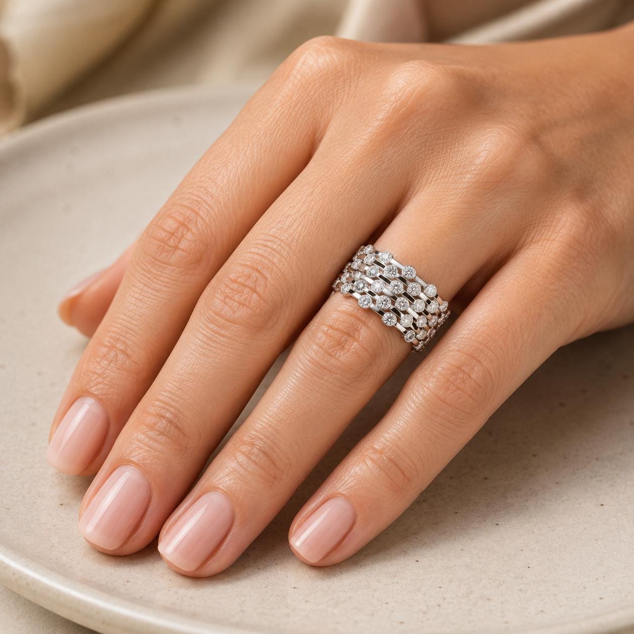 A close-up of a hand wearing a ring with multiple diamonds.