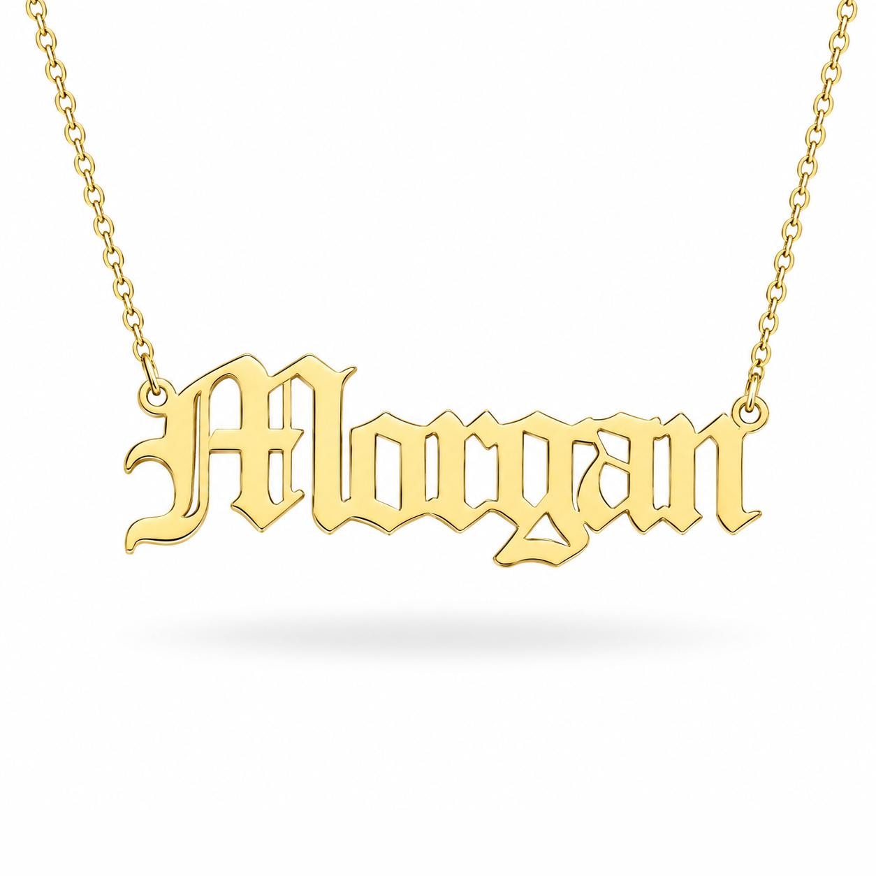 A gold-colored necklace with the name "Morgan" engraved on it.