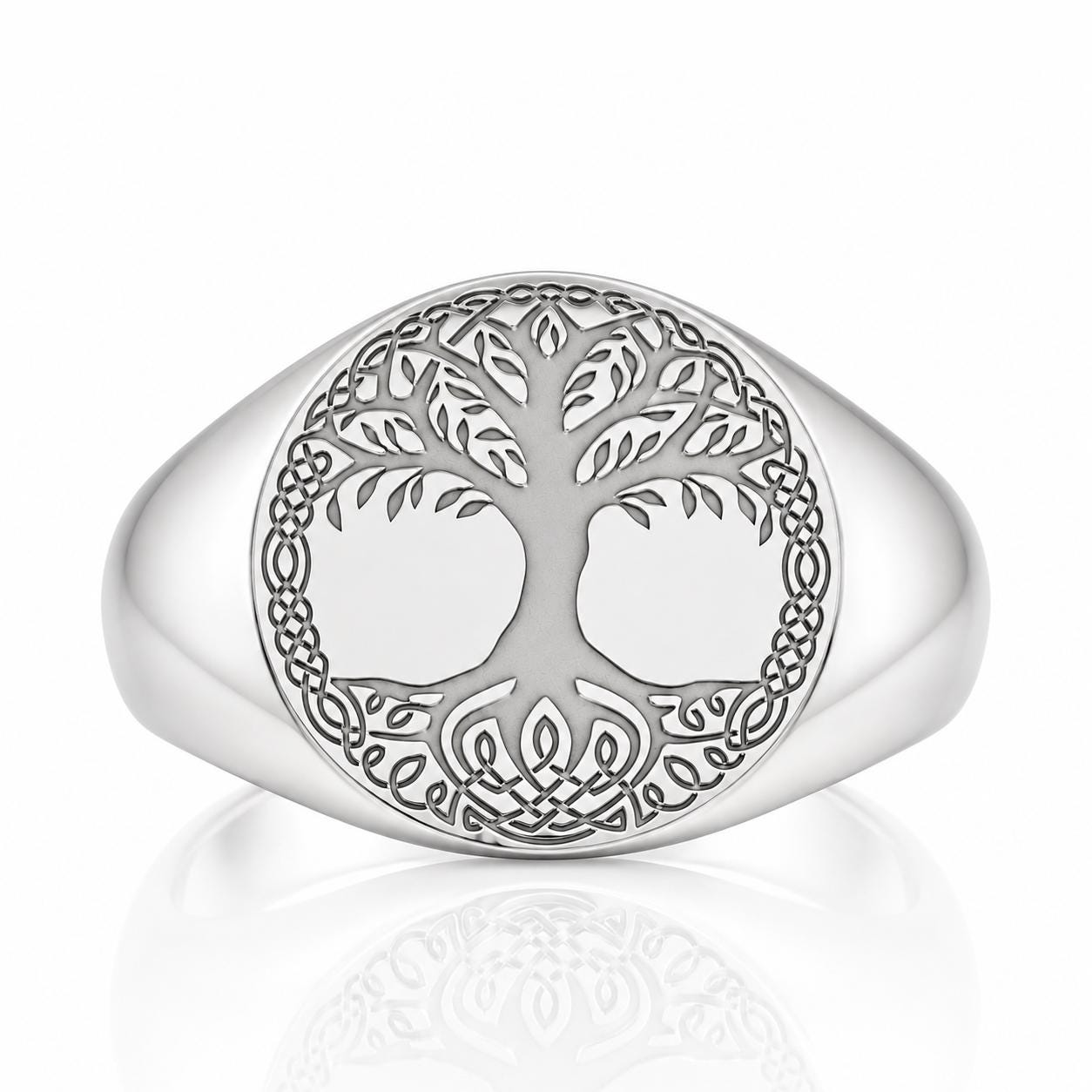 A silver ring with a circular design featuring a tree with a Celtic knot pattern.