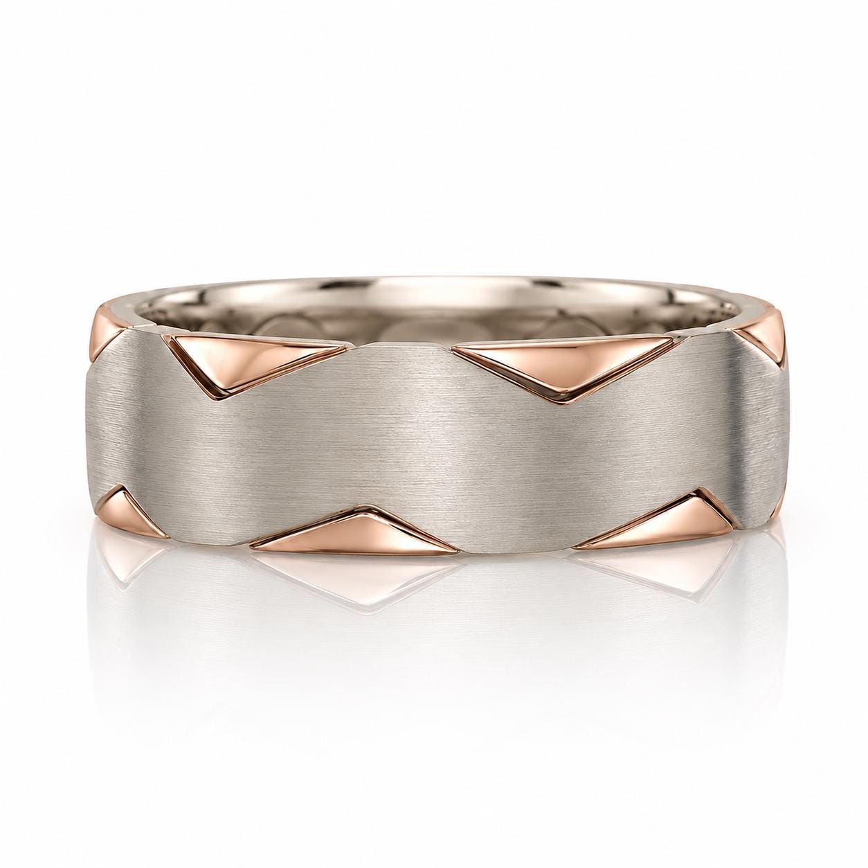 A silver ring with a geometric design featuring triangular shapes in silver and gold tones.