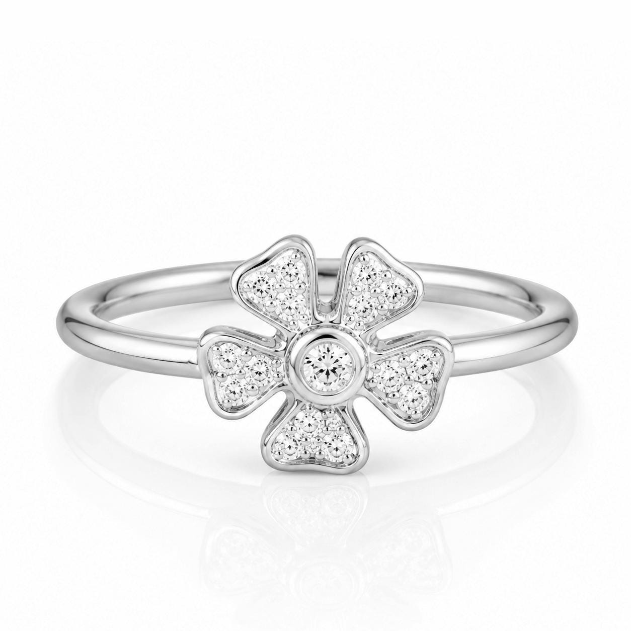 A silver ring with a large diamond in the center, surrounded by smaller diamonds, creating a beautiful flower-like design.