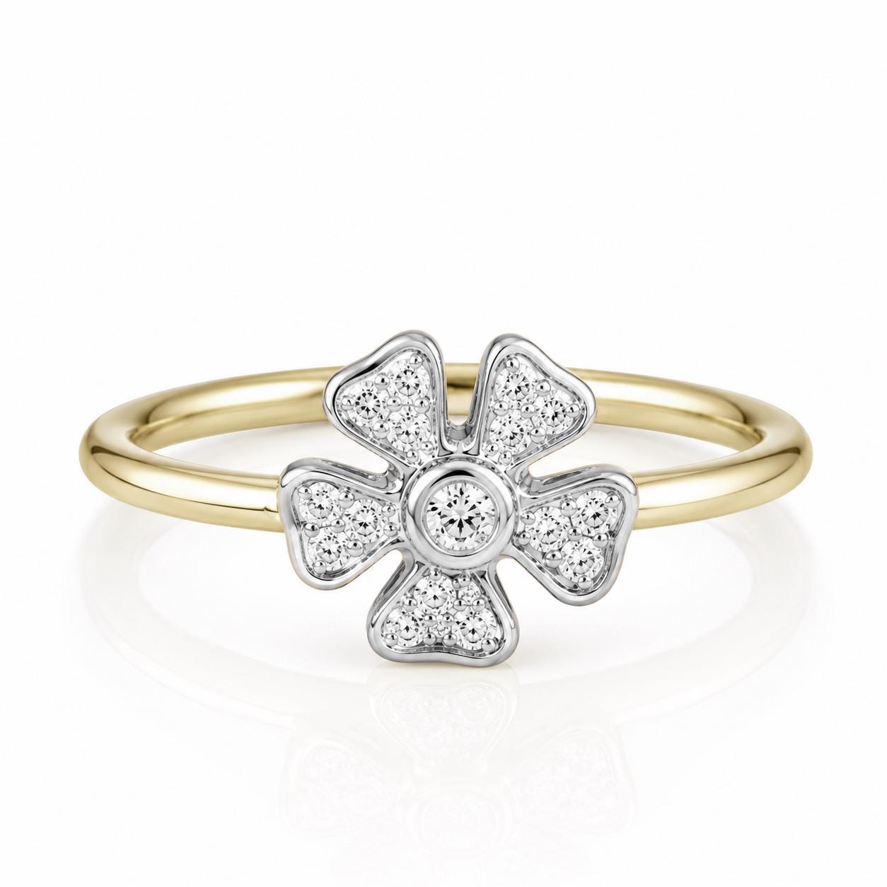 A gold ring with a diamond-encrusted flower-shaped gemstone at its center.