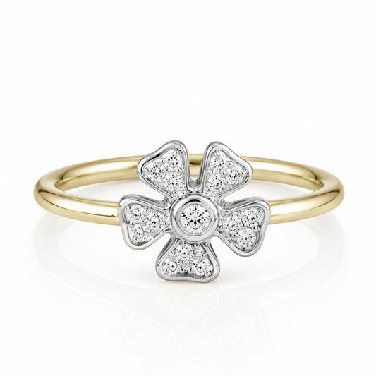 A gold ring with a diamond-encrusted flower-shaped gemstone at its center.