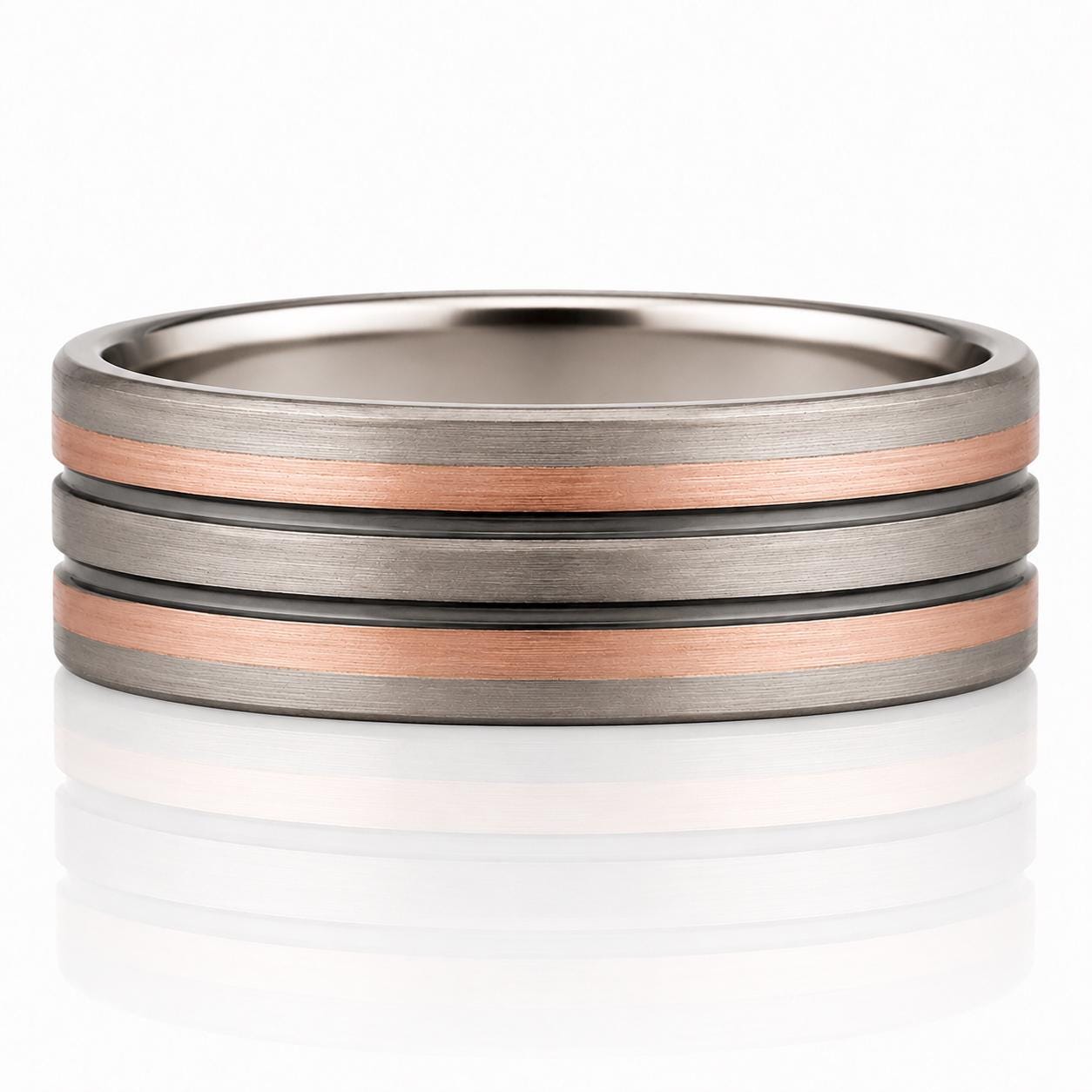 A silver ring with three concentric bands of different colors - gray, copper, and black.