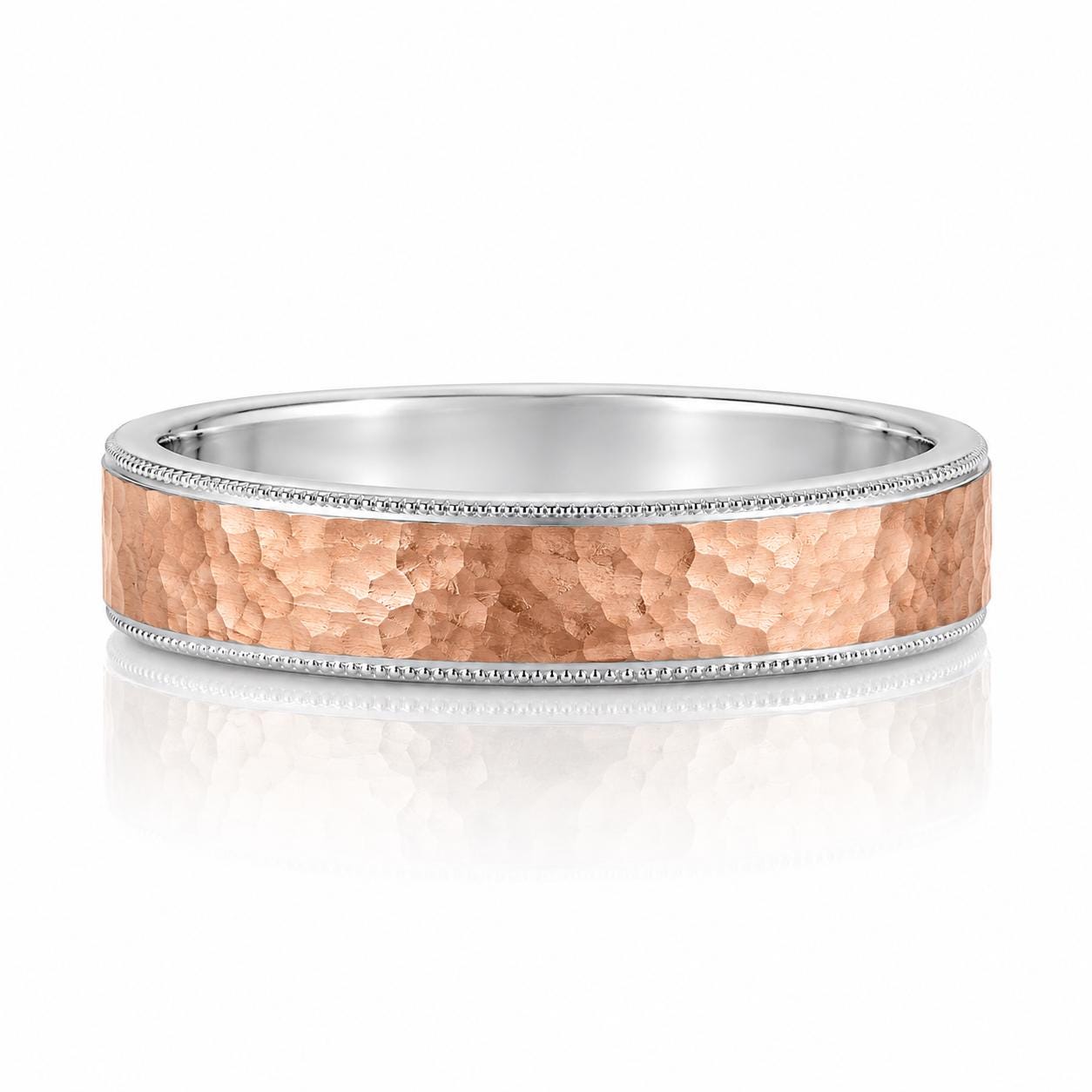 A silver ring with a textured, metallic band and a small, decorative accent detail.