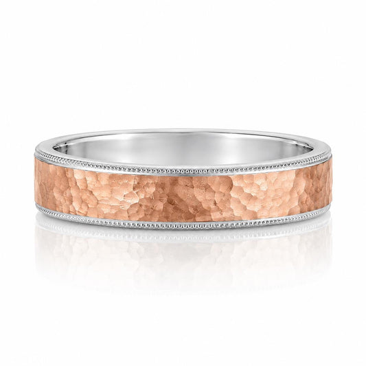 A silver ring with a textured, metallic band and a small, decorative accent detail.