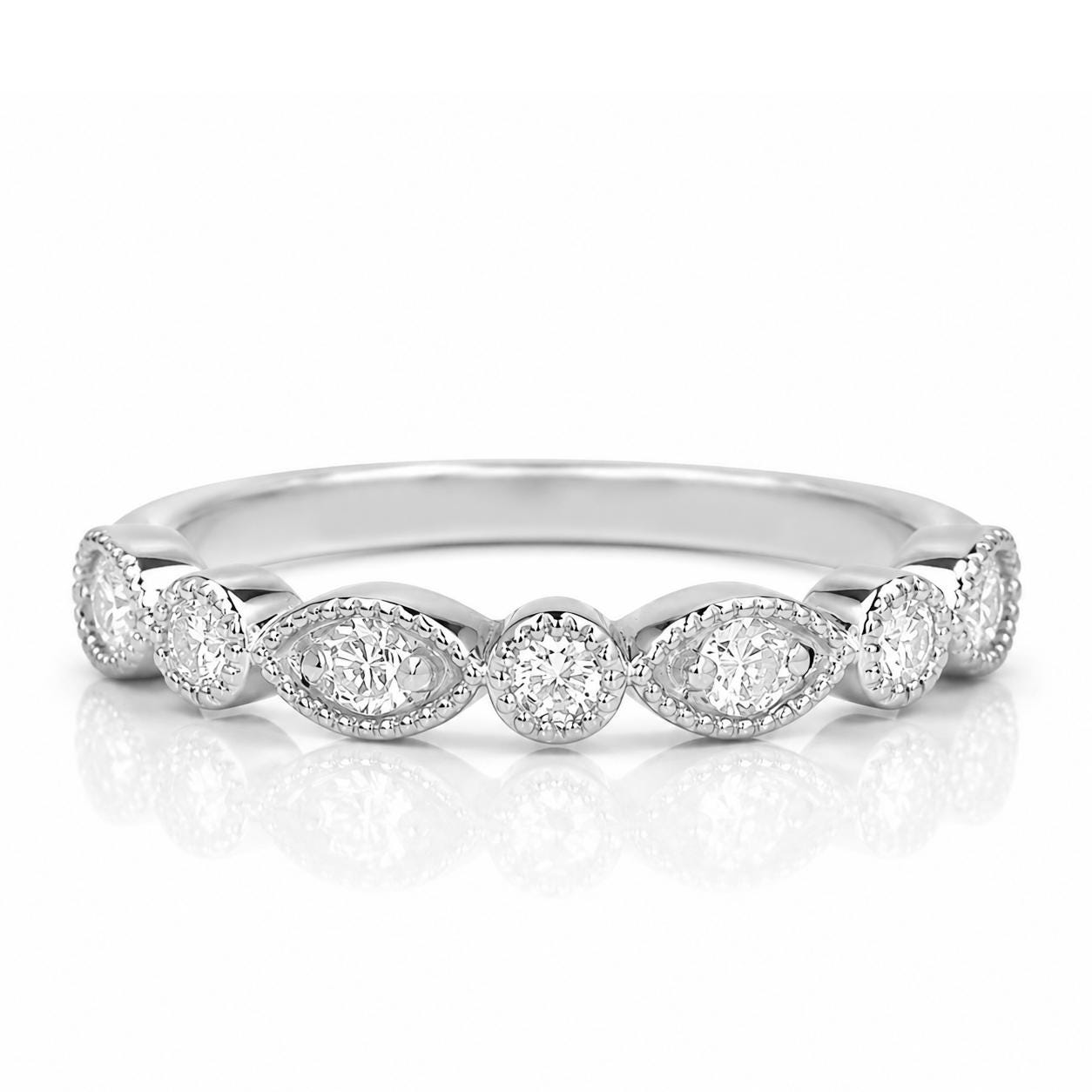 A silver ring with a row of small diamonds set in the center.