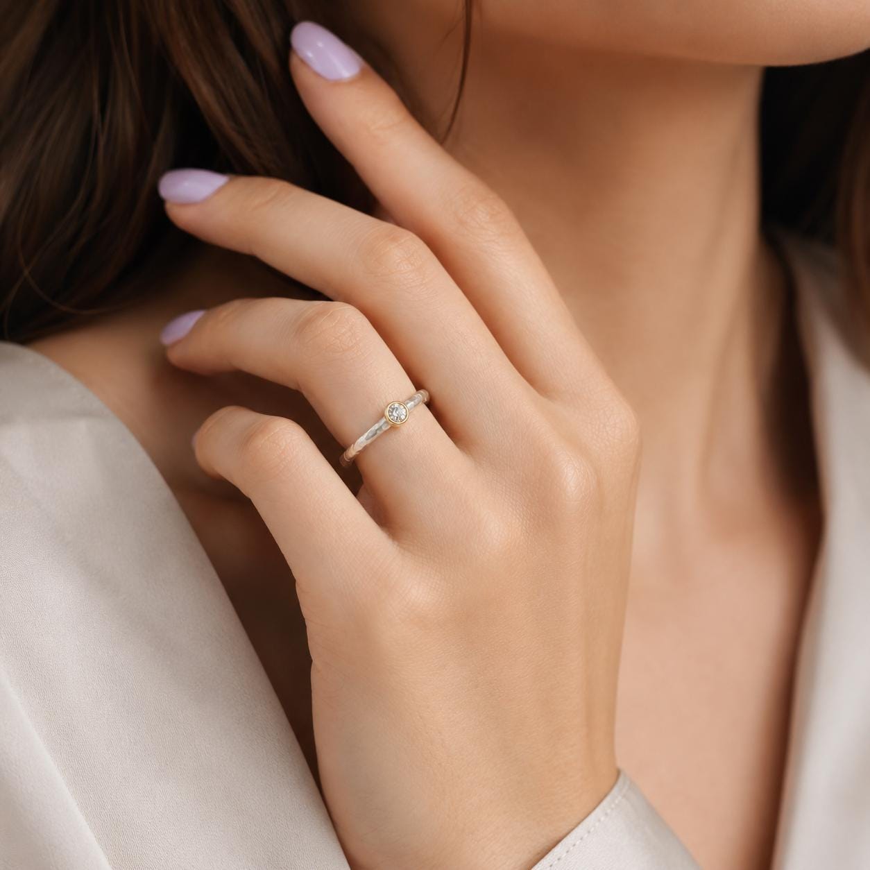 A close-up of a person's hand wearing a ring, with their fingers gently curled around the ring.