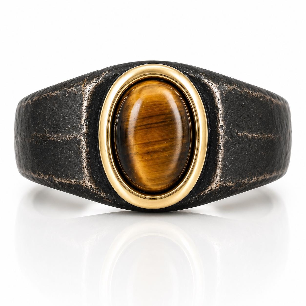 A ring with a large oval-shaped gemstone, possibly a tiger eye, set in a gold-colored metal band.