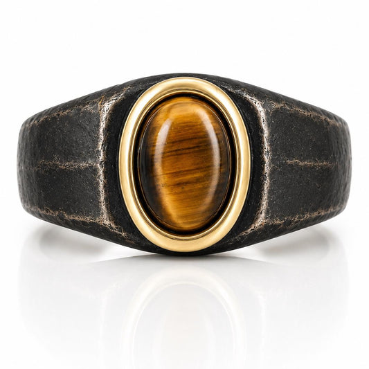 A ring with a large oval-shaped gemstone, possibly a tiger eye, set in a gold-colored metal band.