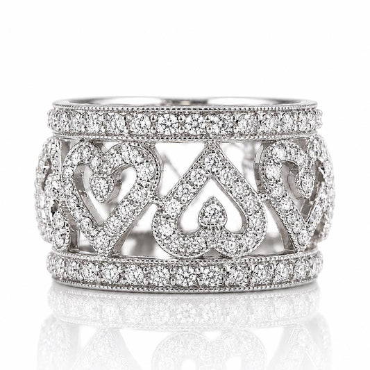 A silver ring adorned with numerous sparkling diamonds, featuring a heart-shaped design.