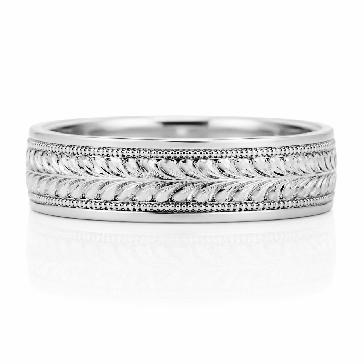 A silver-colored ring with an intricate engraved design featuring a repeating pattern of leaves or branches.
