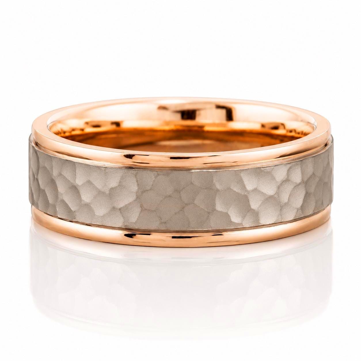 A gold and grey ring with a textured surface, set in a thin gold band.