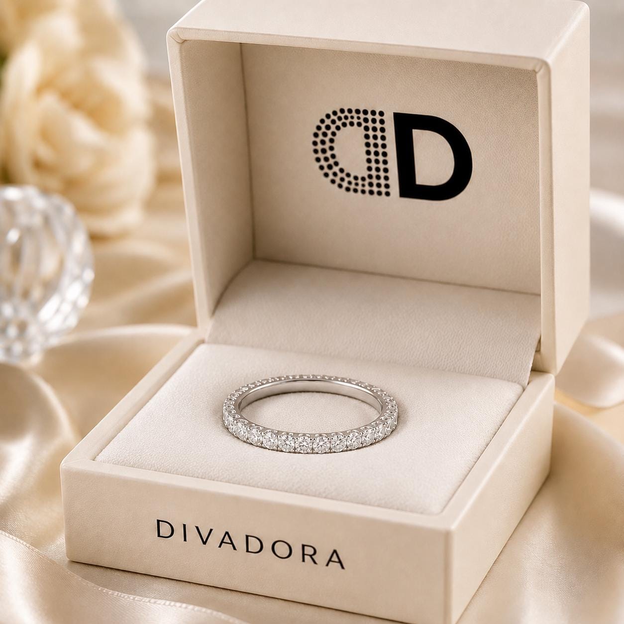 A diamond ring is displayed in a white jewelry box with the brand name "DIVADORA" printed on it.