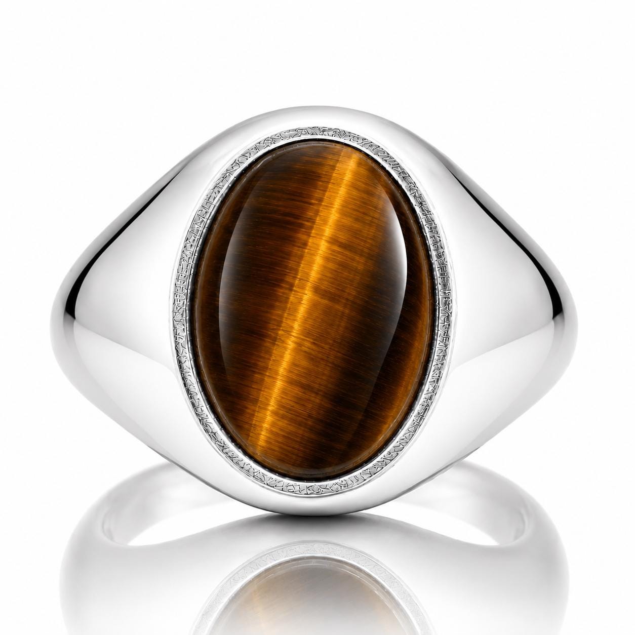 A silver ring with a large oval-shaped gemstone, likely a tiger's eye, set in the center.