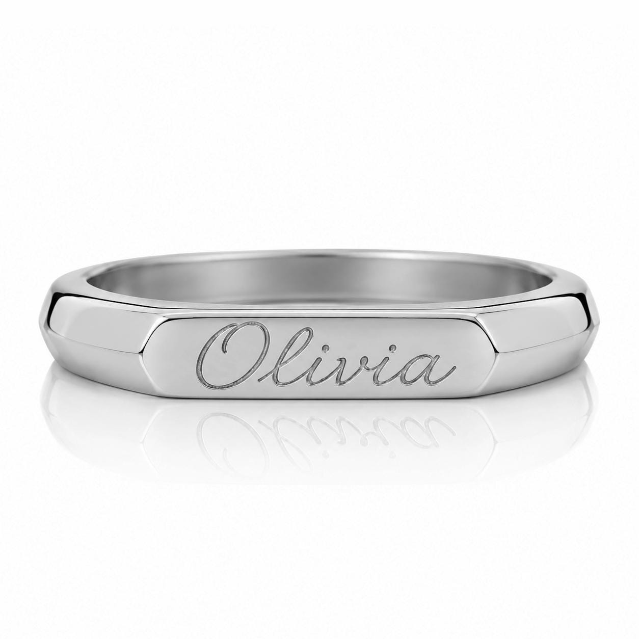 A silver-colored ring with the name "Olivia" engraved on it.