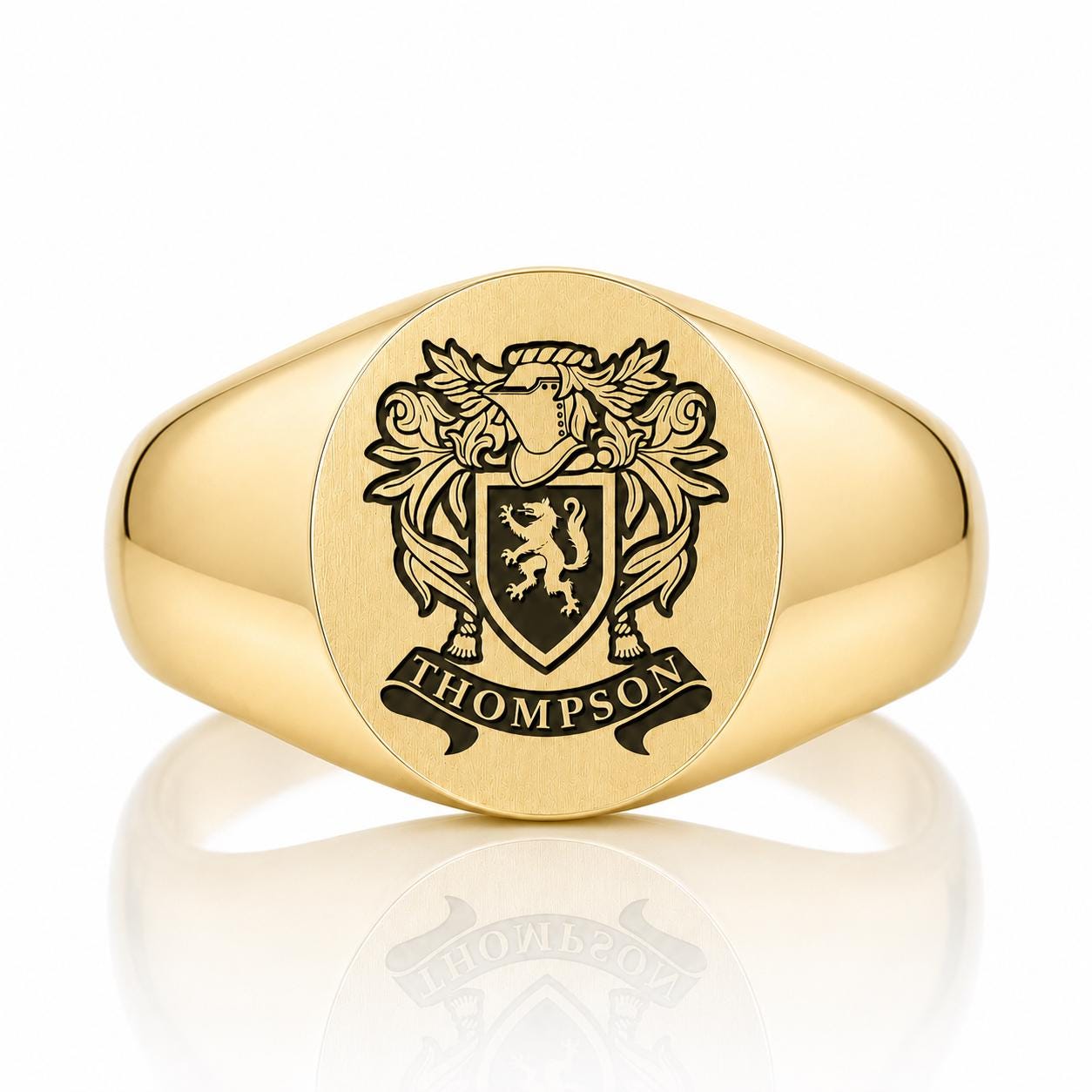 A gold ring with a crest engraved on it.