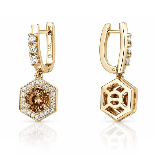 two gold earrings with hexagonal shapes and gemstone accents.