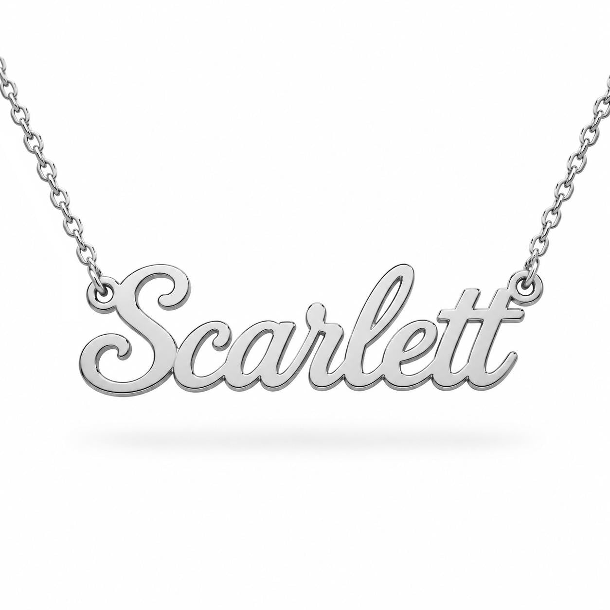 A silver necklace with the name "Scarflet" engraved on it.