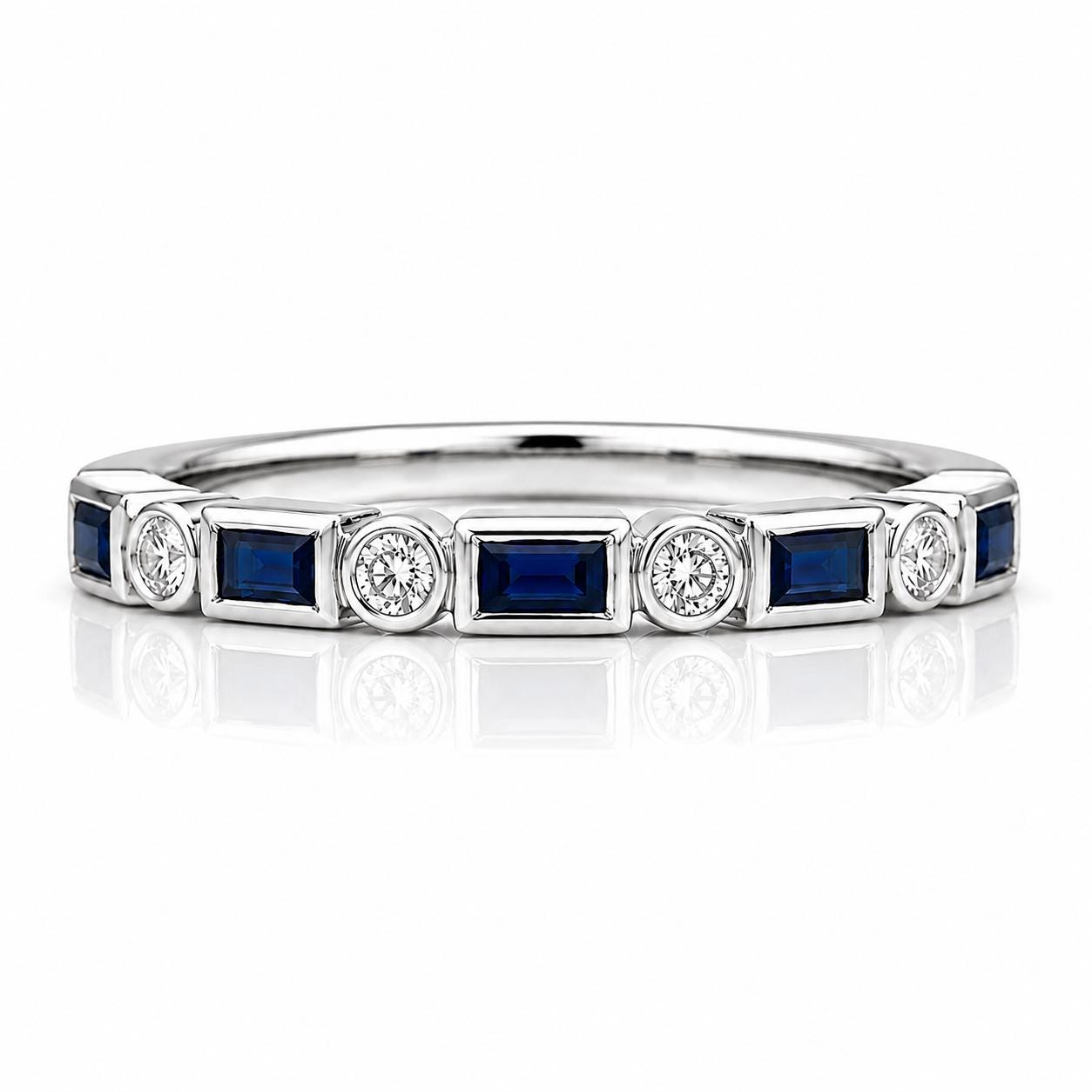 A silver ring with a row of blue and white gemstones set in it.