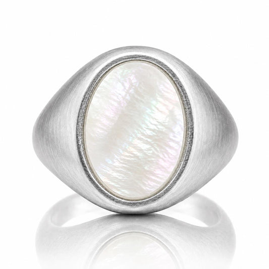 A silver ring with a large oval-shaped pearl in the center.