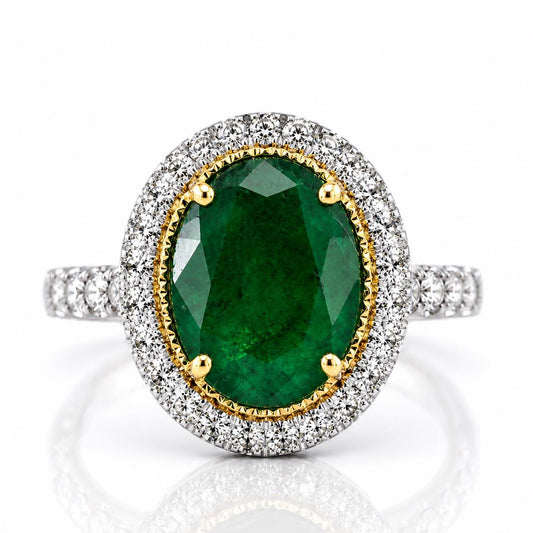 A stunning ring featuring a large oval-shaped green gemstone surrounded by a halo of smaller diamonds set in a silver band.