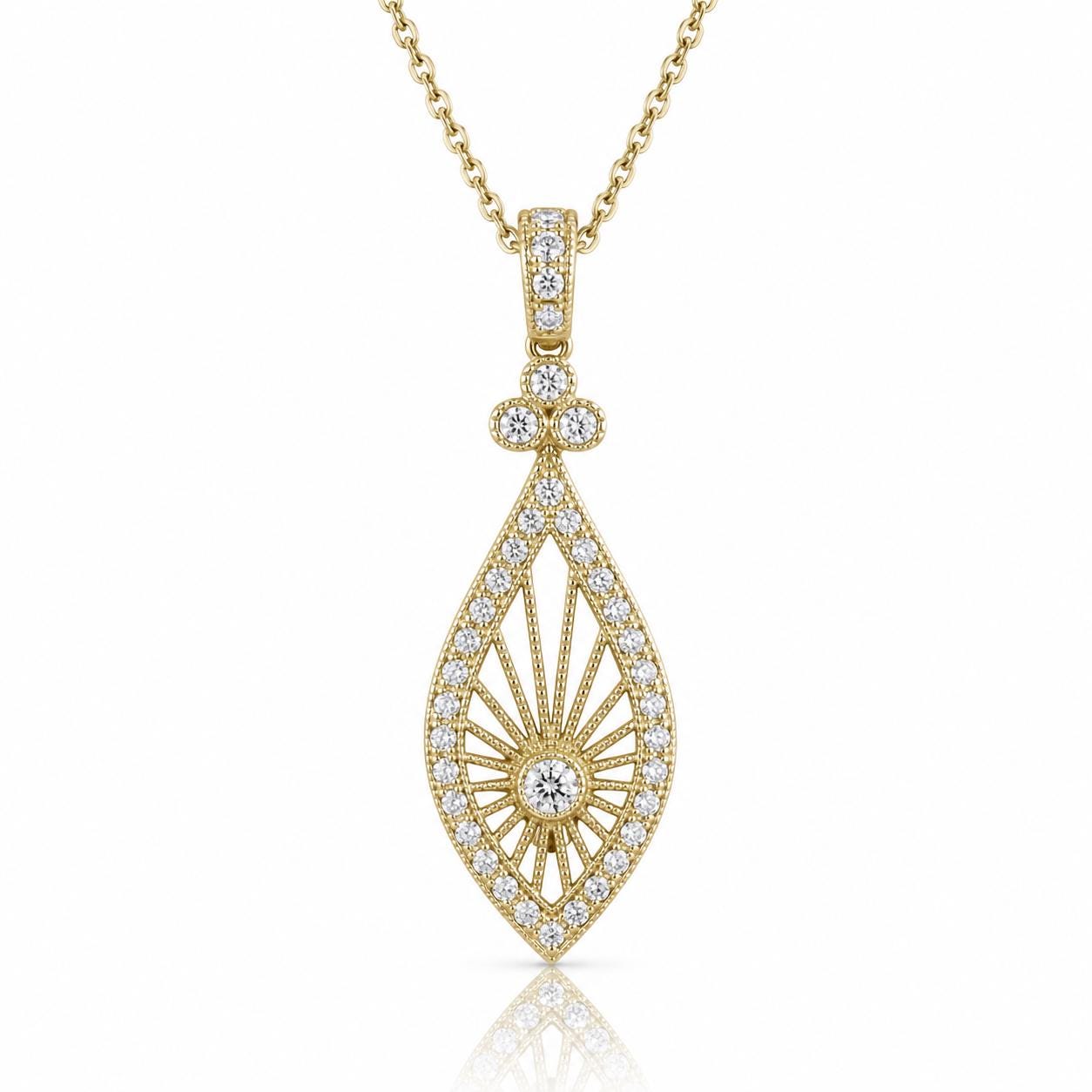 A gold necklace with a pendant featuring a large, intricately designed diamond.