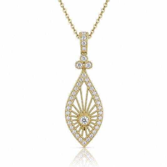 A gold necklace with a pendant featuring a large, intricately designed diamond.